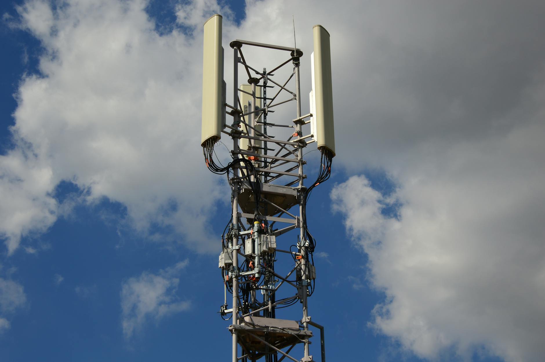 High-angle view of a modern mobile tower against a blue sky, illustrating early next-generation network infrastructure.