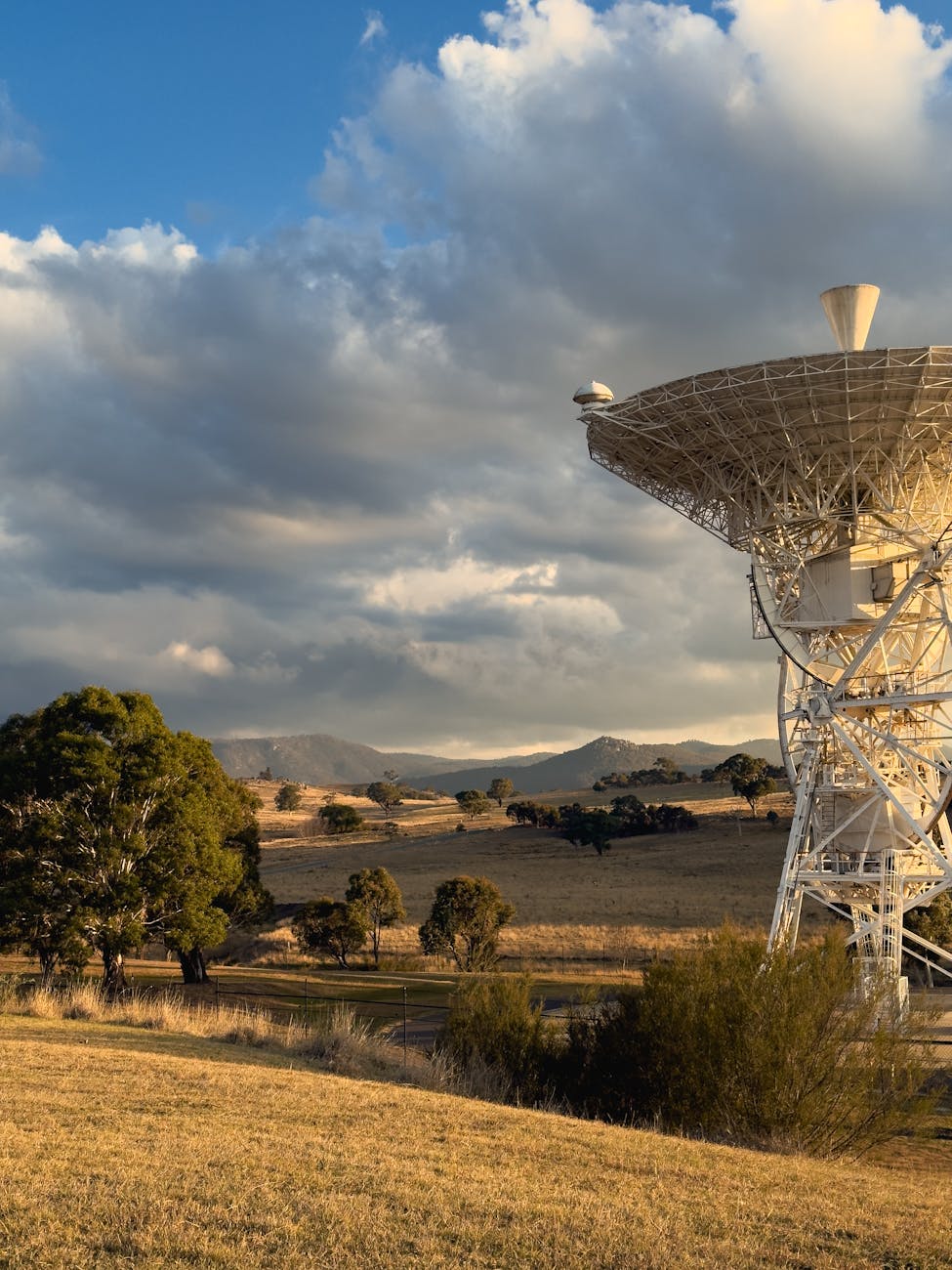 Satellite dish overlooking the Australian countryside at sunset