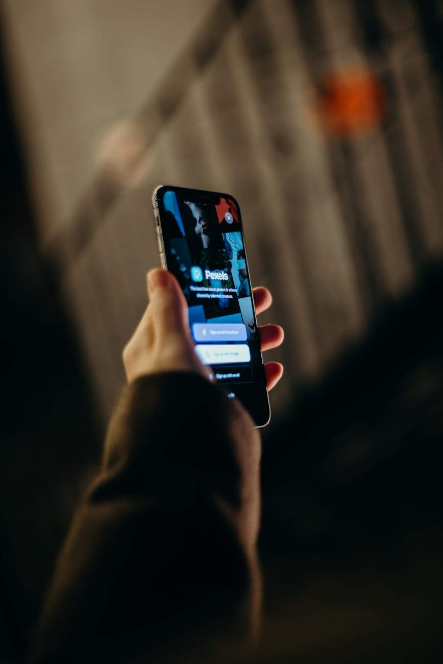 Person using a smartphone near a laptop to illustrate secure digital sign-in